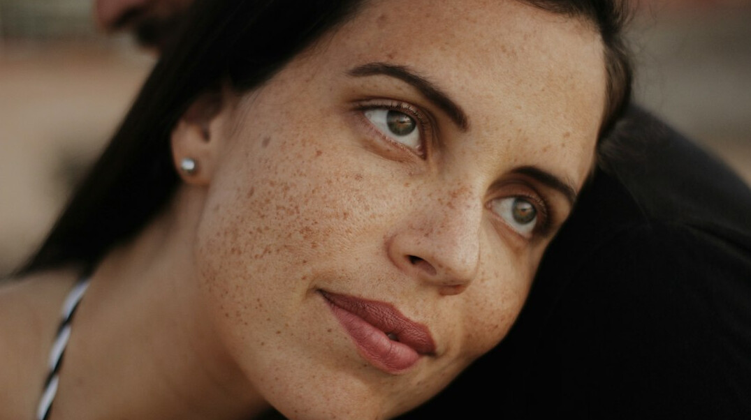 Portrait of a woman with dark hair looking at the camera