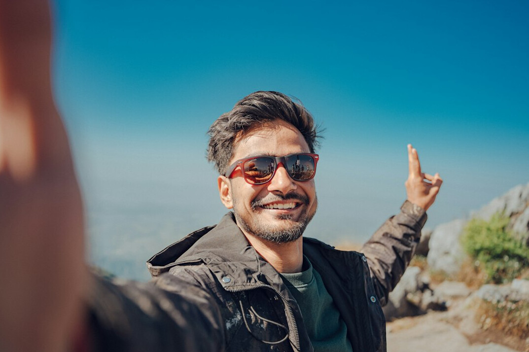 Portrait of a young man smiling outdoors
