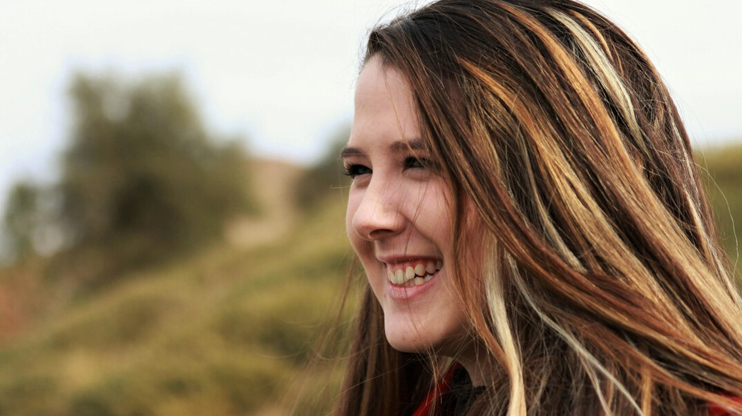 Portrait of a young woman with long hair smiling